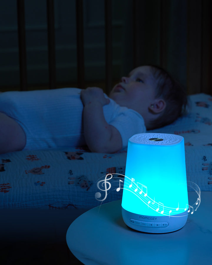 Momcozy Smart Baby Sound Machine with blue light and musical notes, designed for soothing babies.