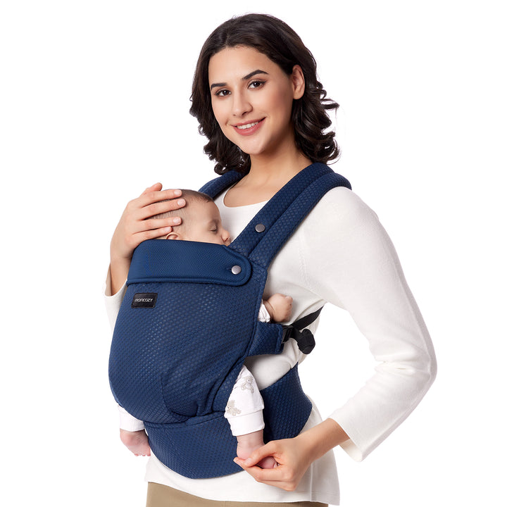 Momcozy navy ergonomic baby carrier cradling sleeping baby, designed for comfort and support.