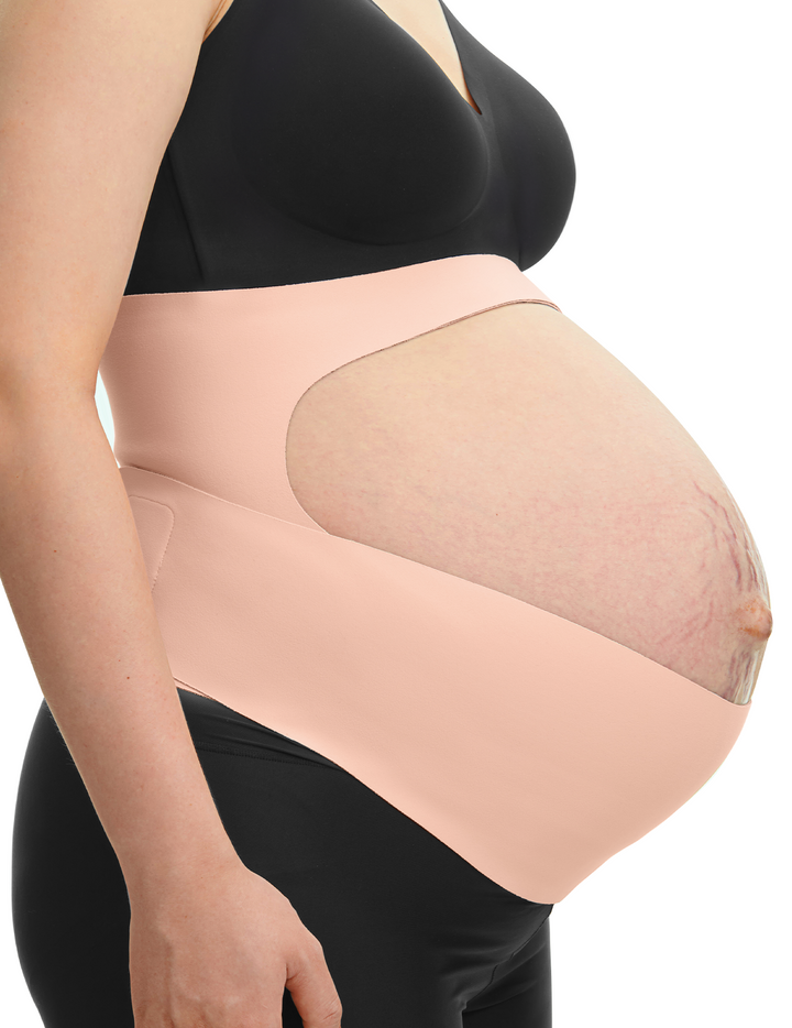 Side view of a pregnant woman wearing an oyster pink Momcozy Ergonest Maternity Belly Band for support.