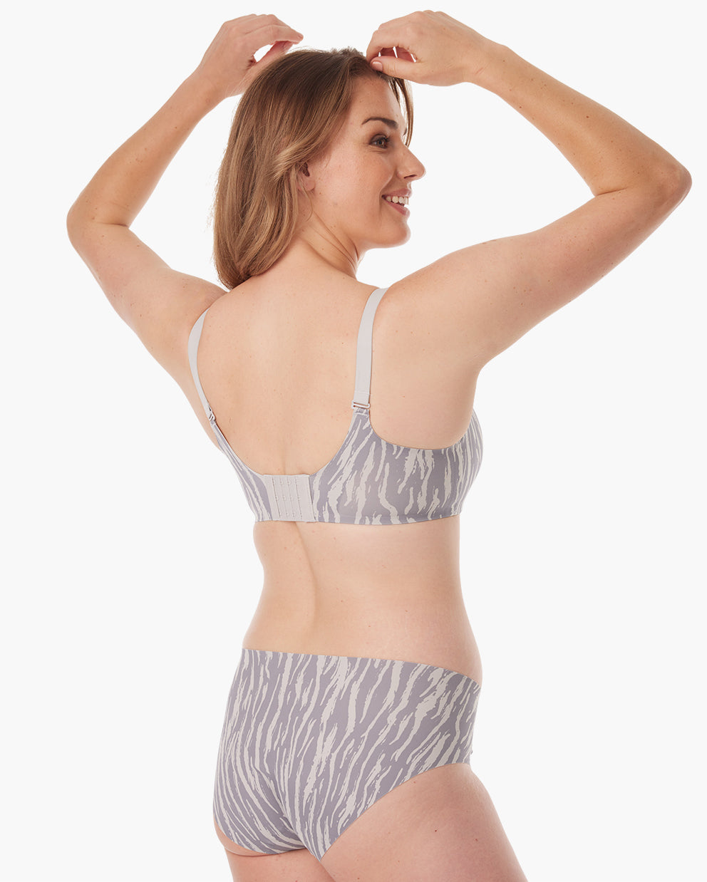 Woman showcasing ultra-soft gray zebra maternity nursing bra from the back.