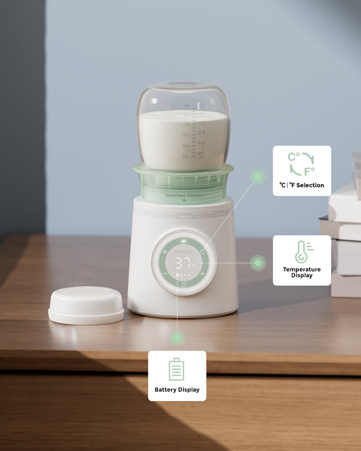 Cordless portable baby bottle warmer with temperature and battery displays on a table.