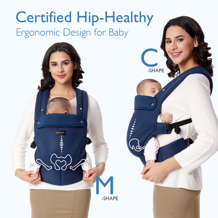 Woman in navy Momcozy ergonomic baby carrier promoting hip-healthy M-shape and C-shape designs.