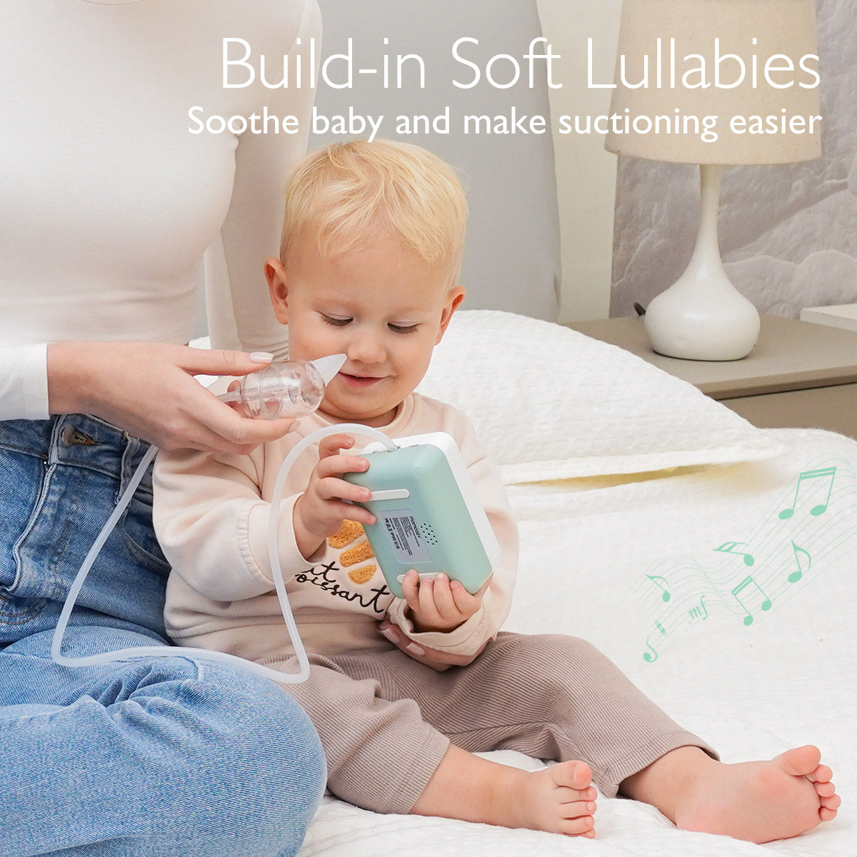 Momcozy Hospital Grade Nasal Aspirator in use with baby, featuring build-in soft lullabies for easier suctioning