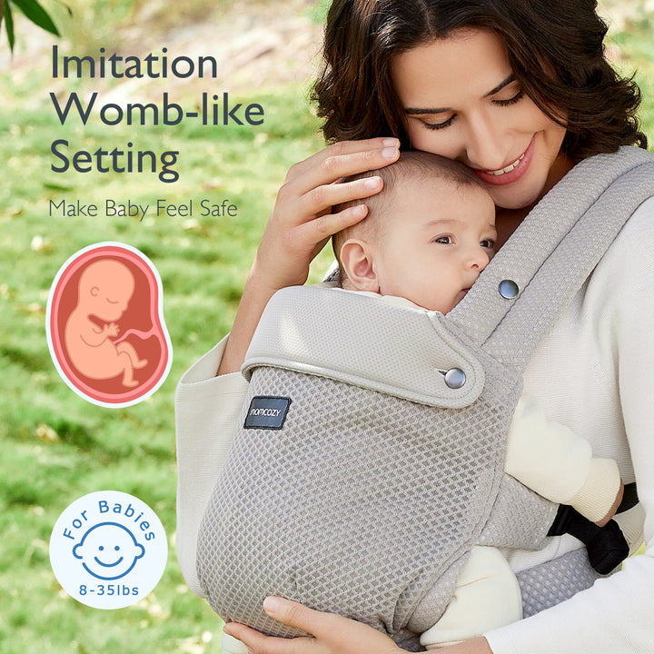 Momcozy gray ergonomic baby carrier promoting womb-like setting for infants 8-35 lbs.