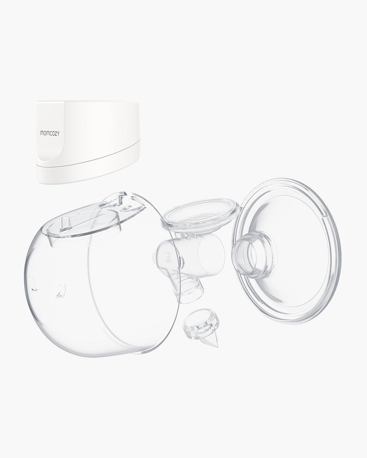 Disassembled Momcozy S12 Pro breast pump components including clear shield and white base.