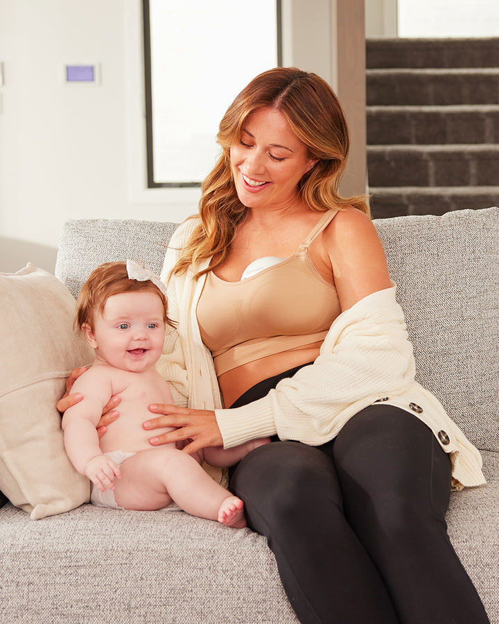 Mother and baby enjoying quality time together, showcasing Momcozy's wearable breast pump.