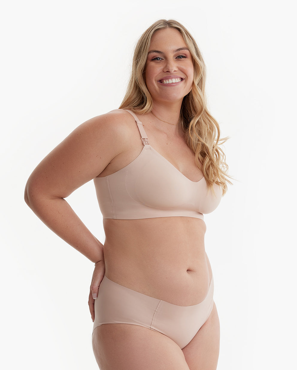 Smiling model in light nude YN21 Ultra Soft Seamless Nursing Bra, showing its flattering, seamless design & M5 pump clips.