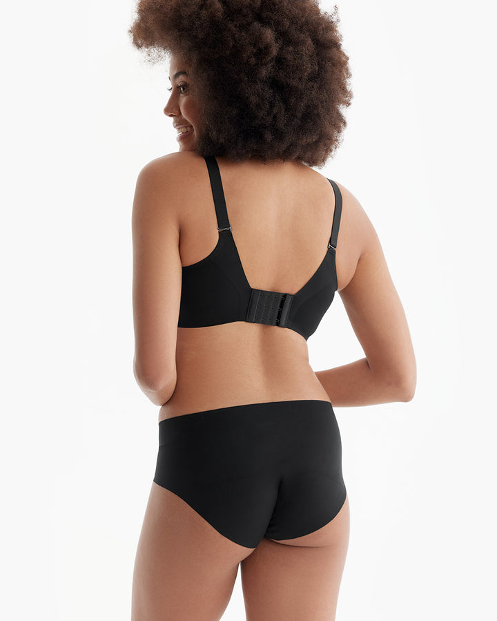 Woman wearing a black pumping bra from Momcozy, showcasing the back view and adjustable straps.